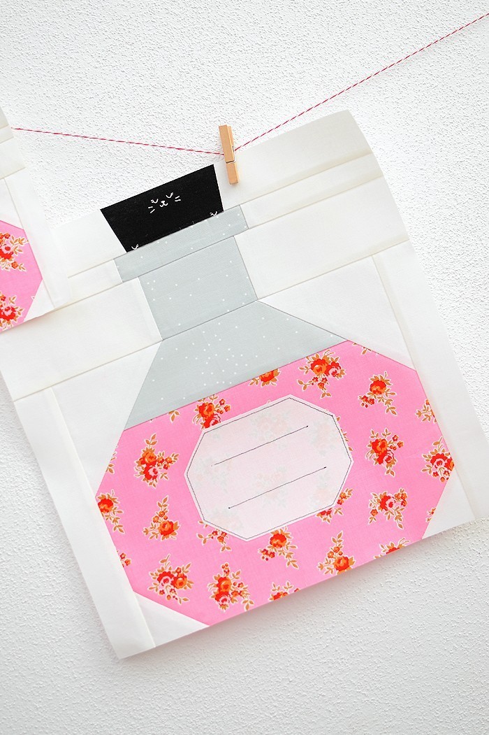 12 Inch Potion Bottle quilt block hanging on a wall