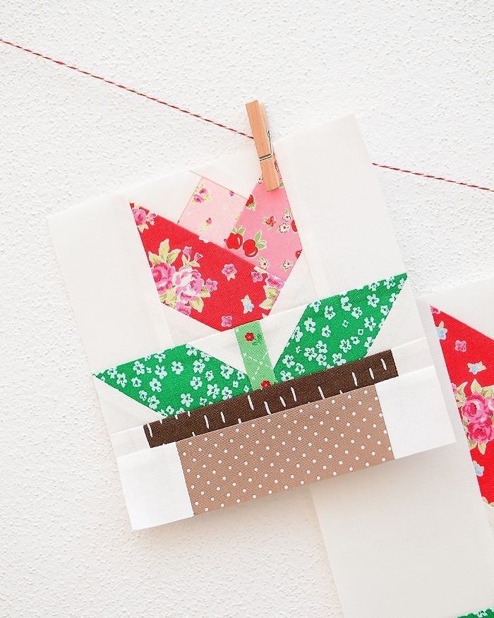 6 Inch Tulip quilt block hanging on a wall
