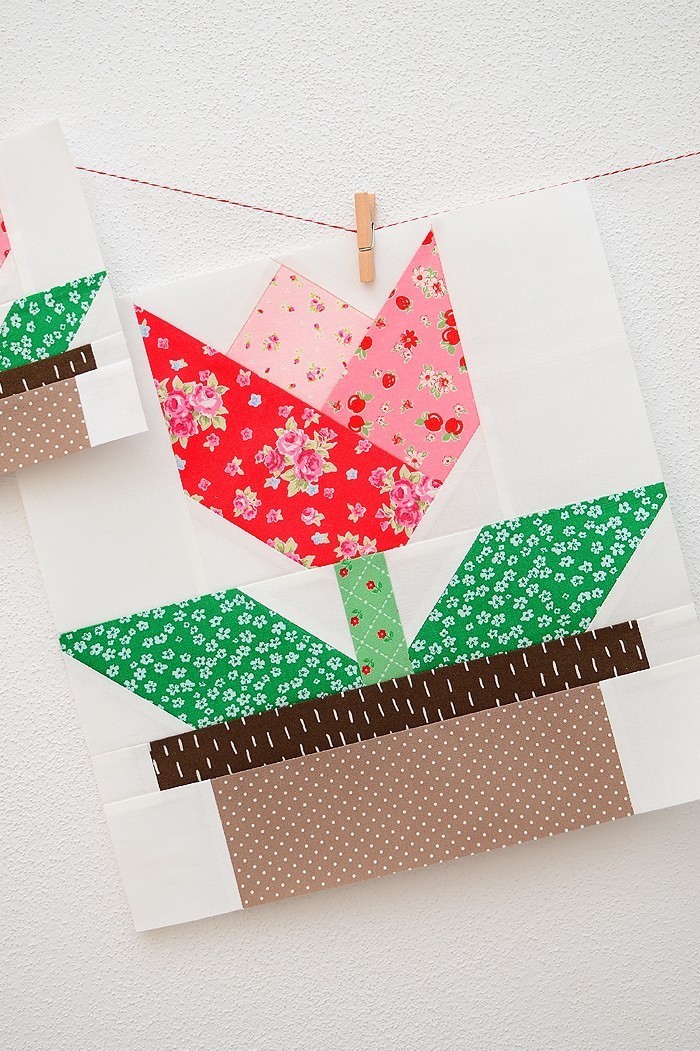 12 Inch Tulip quilt block hanging on a wall